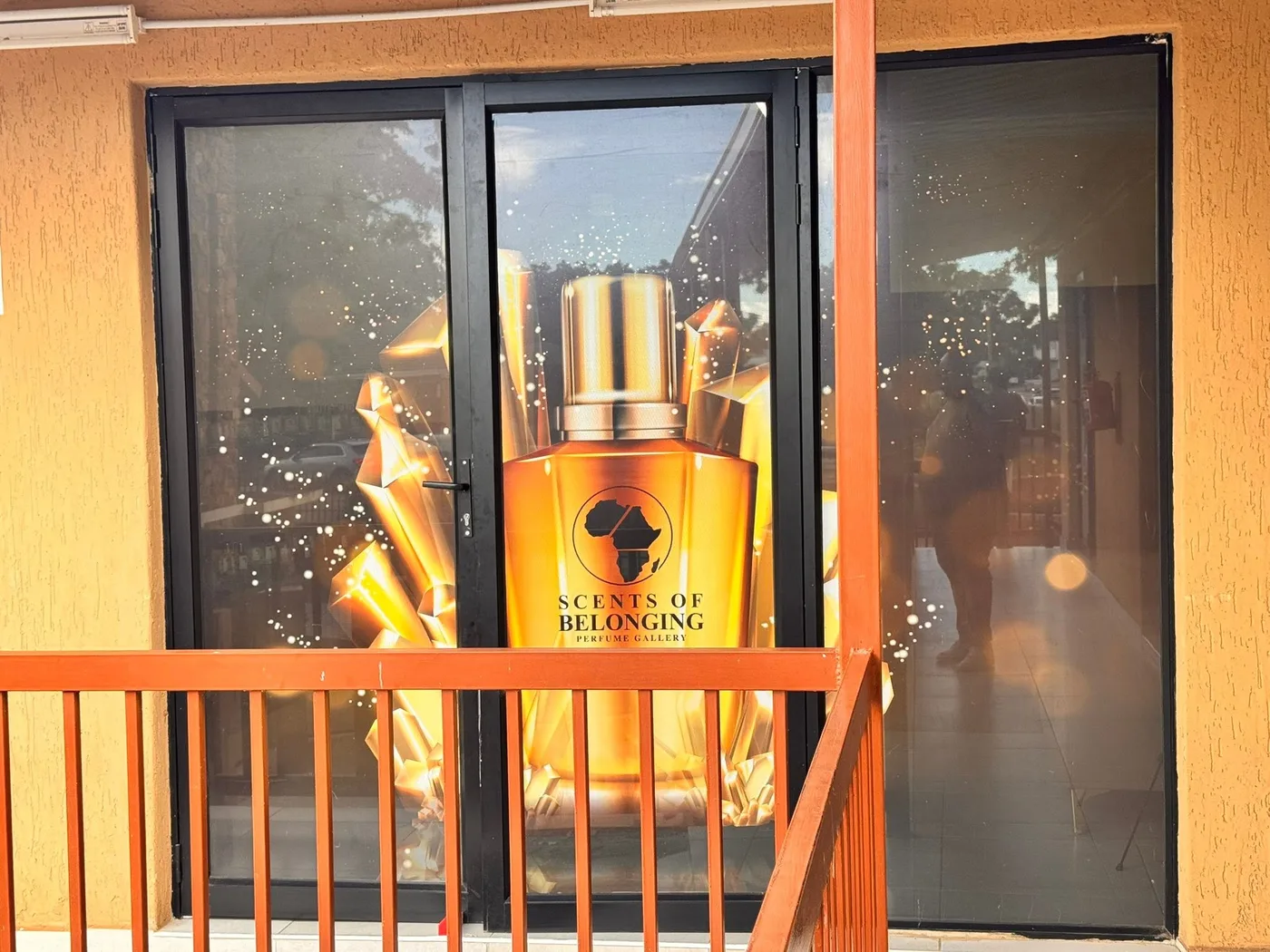 The gallery's front window with the amber bottle mural