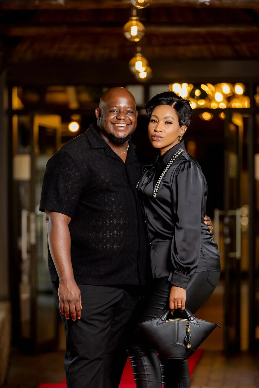 Oscar and Thandeka Mabunda, the founders of Scents of Belonging, dressed in black on a red carpet